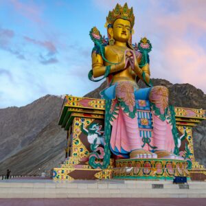 Majestic Maitreya Buddha statue at Diskit Monastery in Nubra Valley, India during sunset.